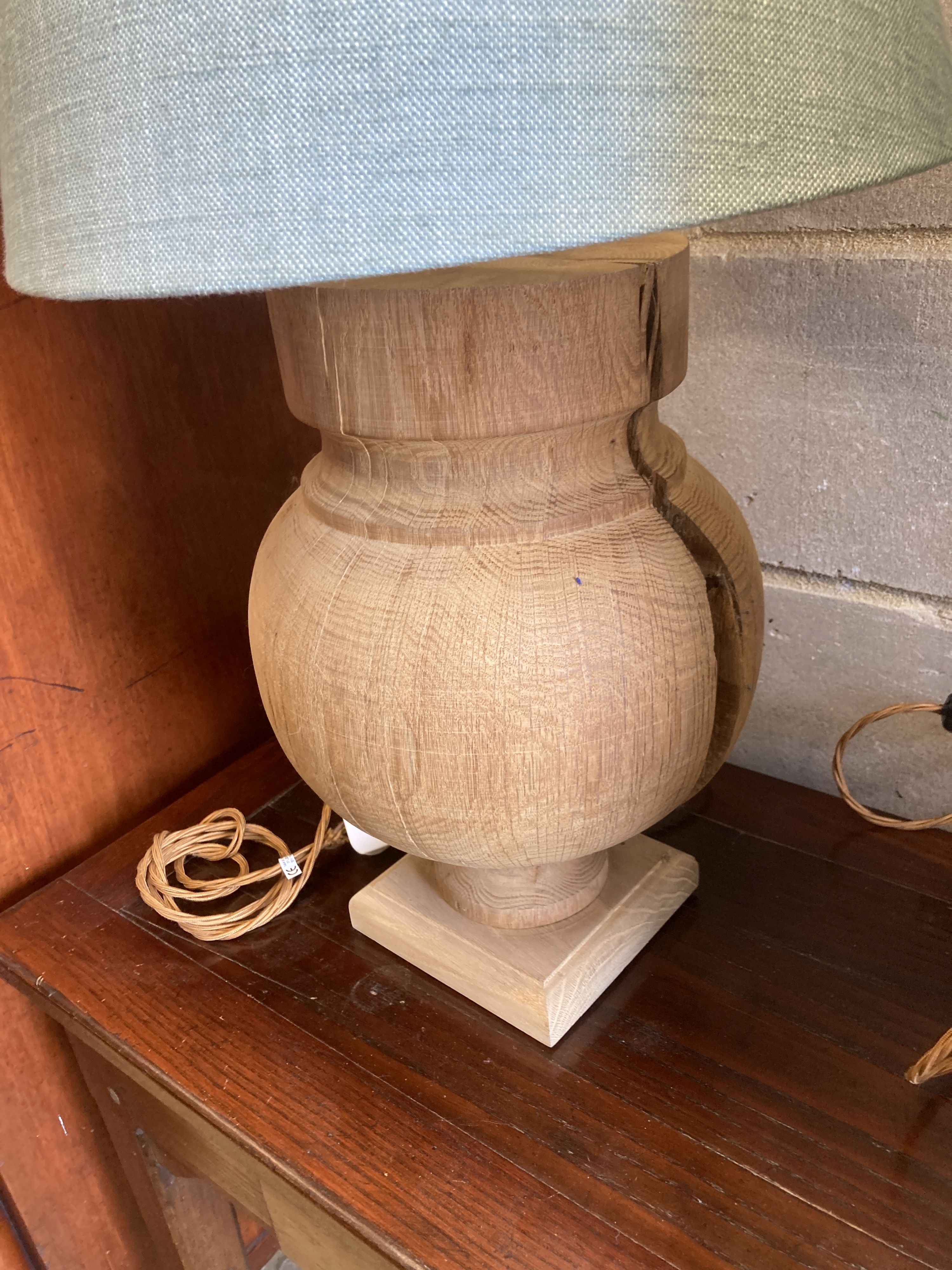 A pair of contemporary turned oak table lamps with shades, height 70cm